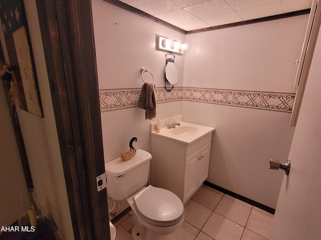 bathroom featuring tile patterned flooring, toilet, and vanity