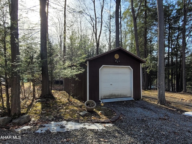 detached garage with gravel driveway