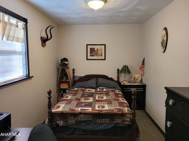 bedroom with baseboards and carpet floors