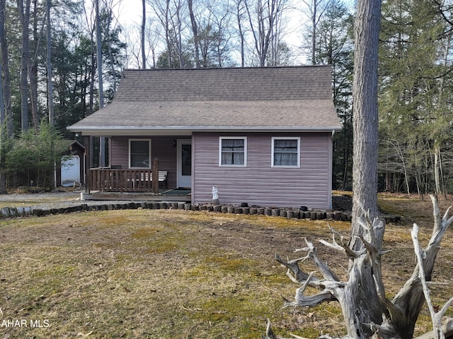 view of front of home featuring covered porch and a shingled roof