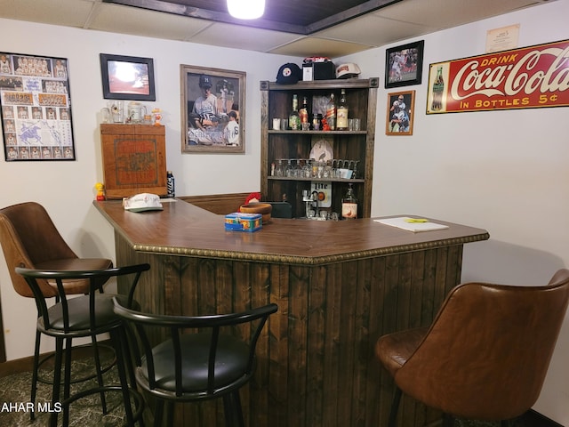 bar with a bar and a paneled ceiling