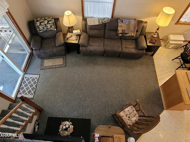 living room with stairs and carpet flooring