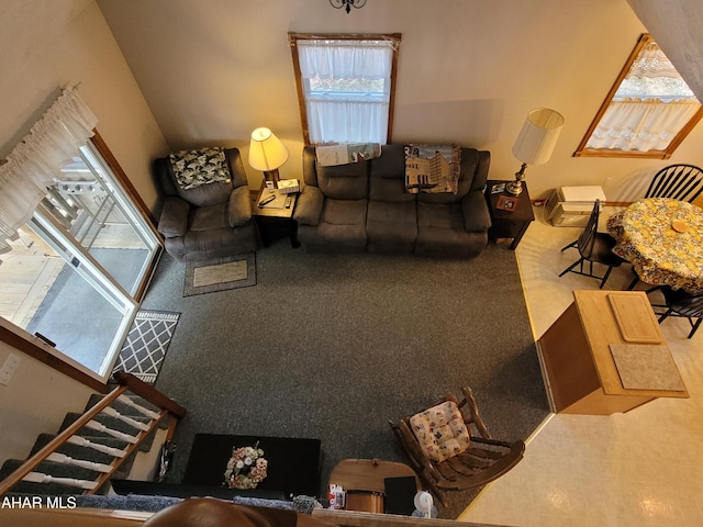 carpeted living room featuring stairs