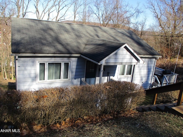 view of front of property featuring roof with shingles