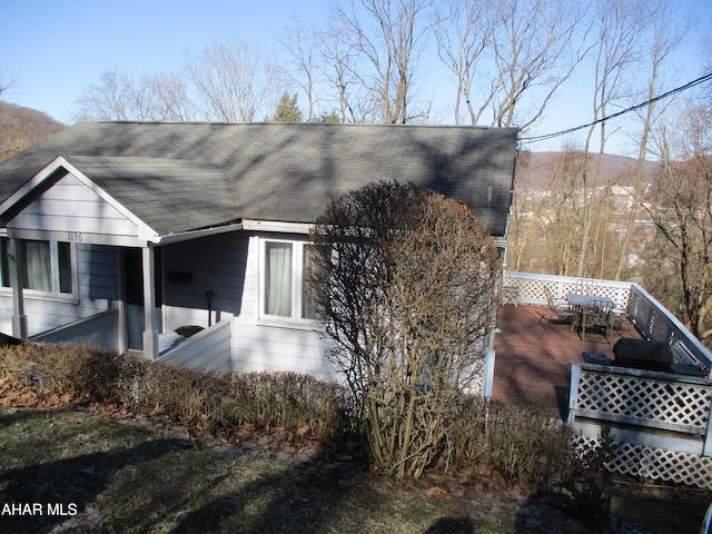 view of side of property with a wooden deck