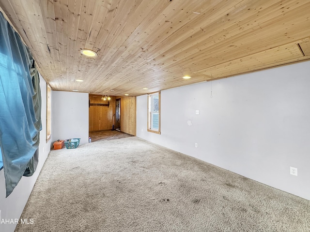 basement with wooden walls, carpet, and wood ceiling