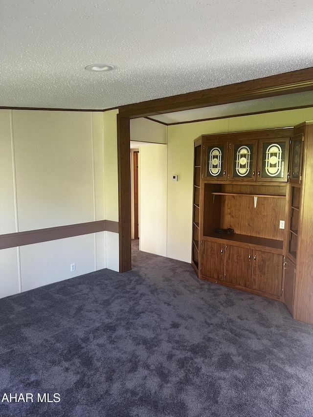 carpeted spare room featuring a textured ceiling