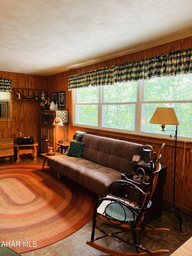 living room with parquet flooring and wooden walls