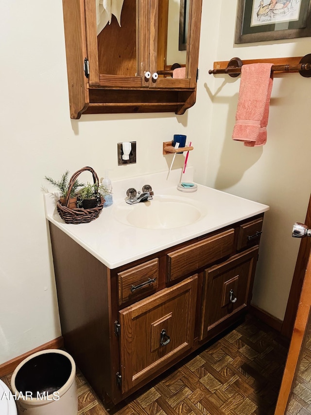 bathroom with parquet flooring and vanity