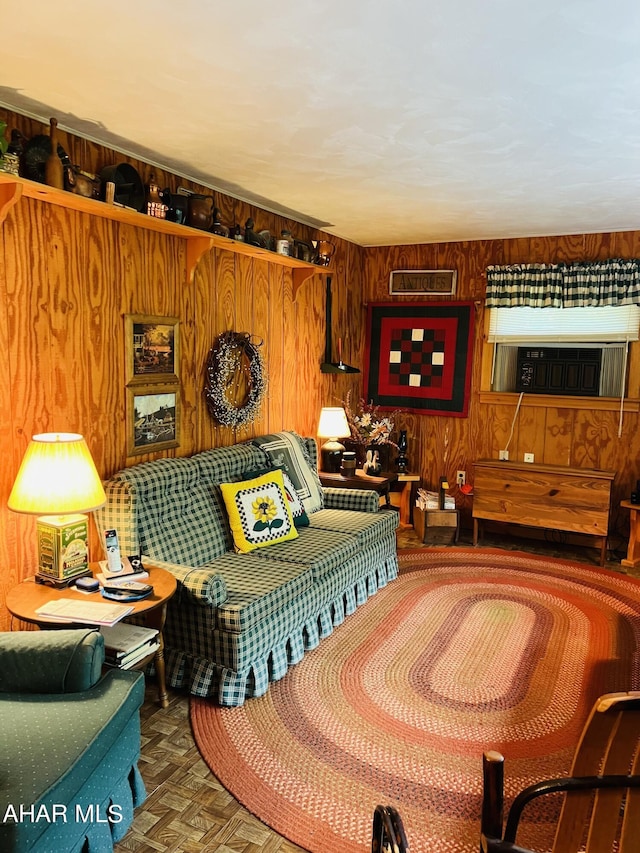 sitting room with parquet flooring and wooden walls