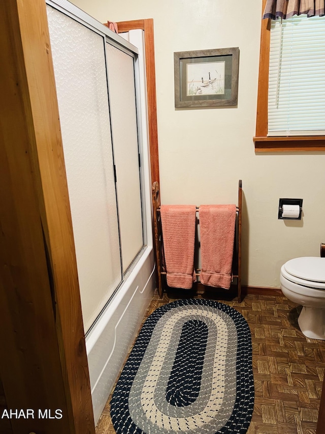 bathroom featuring toilet and parquet floors