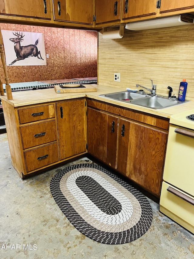 kitchen featuring white stove and sink