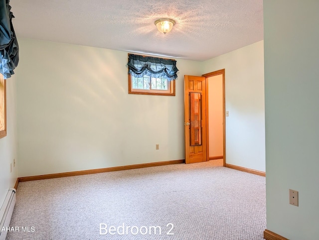 263 Helixville Rd, Schellsburg, PA 15559 - empty room with a baseboard radiator, a textured ceiling, and carpet