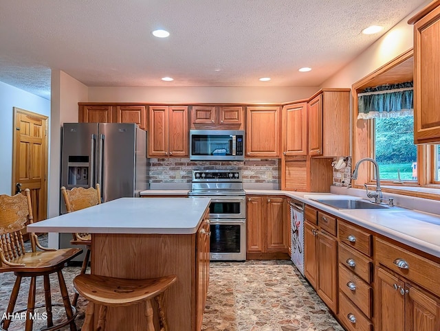 263 Helixville Rd, Schellsburg, PA 15559 - kitchen featuring stainless steel appliances, a breakfast bar area, a textured ceiling, tasteful backsplash, and a center island