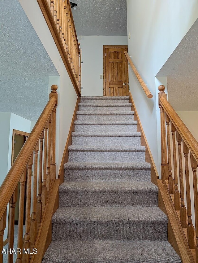 263 Helixville Rd, Schellsburg, PA 15559 - stairway featuring a textured ceiling and baseboards