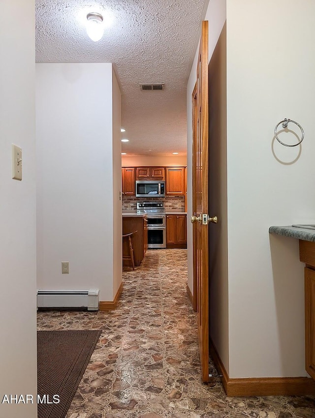 263 Helixville Rd, Schellsburg, PA 15559 - corridor featuring baseboard heating, a textured ceiling, and light stone finish flooring