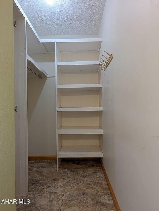 263 Helixville Rd, Schellsburg, PA 15559 - walk in closet featuring stone finish floors