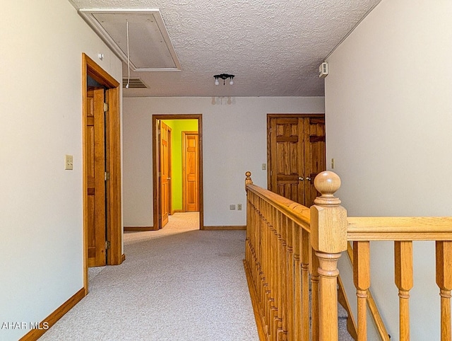 263 Helixville Rd, Schellsburg, PA 15559 - hallway with attic access, an upstairs landing, carpet floors, and a textured ceiling
