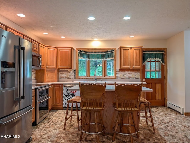 263 Helixville Rd, Schellsburg, PA 15559 - kitchen featuring appliances with stainless steel finishes, a baseboard heating unit, plenty of natural light, recessed lighting, and decorative backsplash