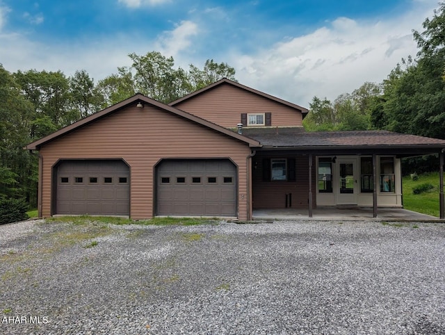 263 Helixville Rd, Schellsburg, PA 15559 - view of front of house featuring a porch, an attached garage, gravel driveway, and roof with shingles