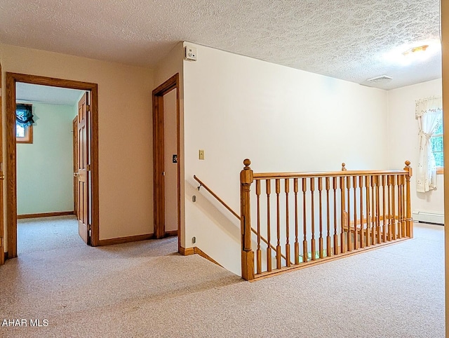 263 Helixville Rd, Schellsburg, PA 15559 - hall featuring an upstairs landing, carpet floors, a baseboard radiator, and a textured ceiling