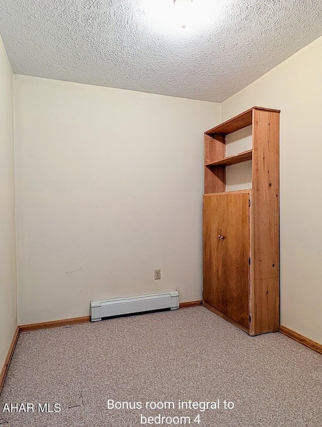 263 Helixville Rd, Schellsburg, PA 15559 - unfurnished room with a baseboard heating unit, carpet flooring, and a textured ceiling