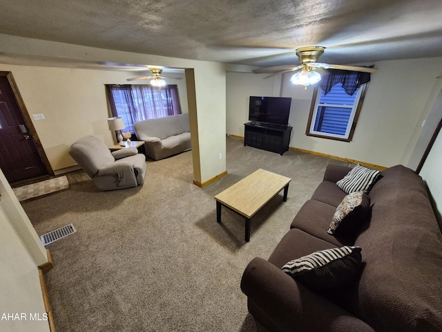 living area with light carpet, baseboards, visible vents, a ceiling fan, and a textured ceiling