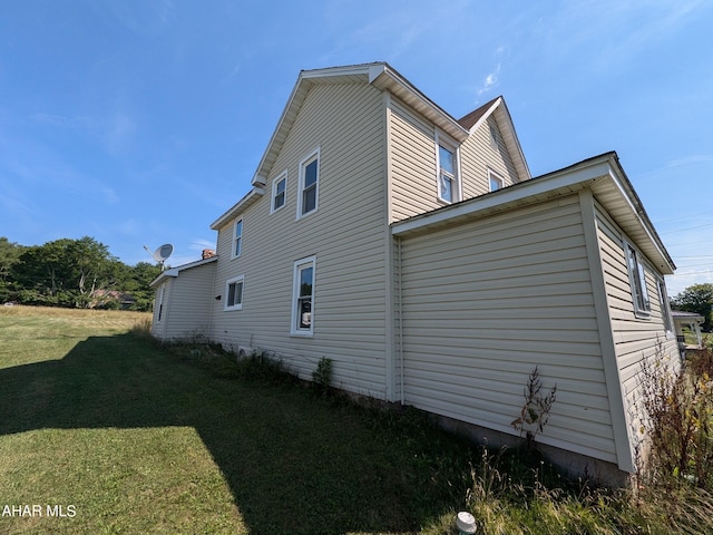 view of home's exterior with a yard