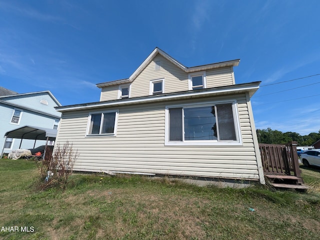 view of side of property featuring a yard and a carport