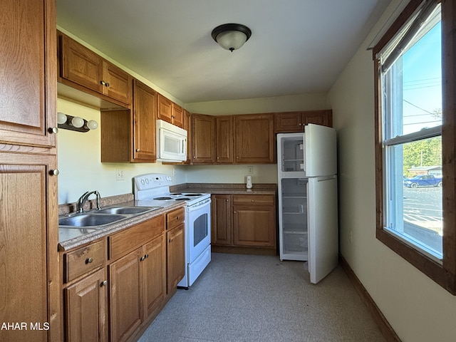 kitchen featuring white appliances and sink