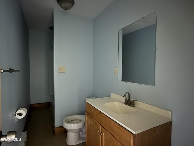 bathroom with tile patterned flooring, vanity, and toilet