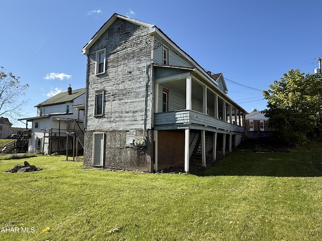 view of property exterior featuring a lawn and a wooden deck