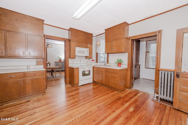 kitchen with white appliances, radiator heating unit, light countertops, light wood-style floors, and crown molding