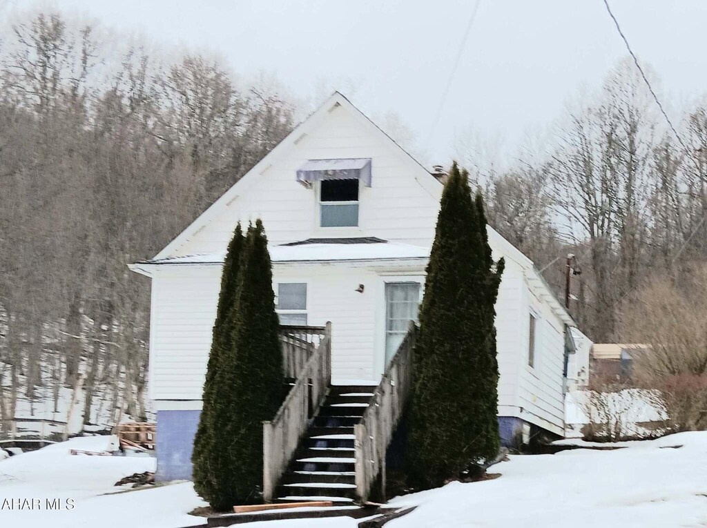 view of side of property with a lawn