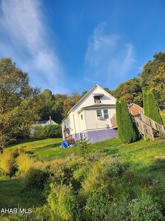 view of side of property with a lawn