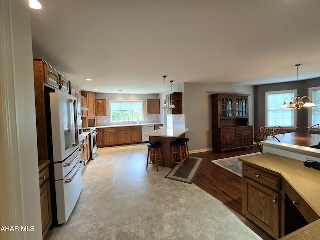 216 Red Fox Dr, Duncansville, PA 16635 - kitchen featuring high end fridge, a chandelier, dishwashing machine, stainless steel gas range, and light countertops
