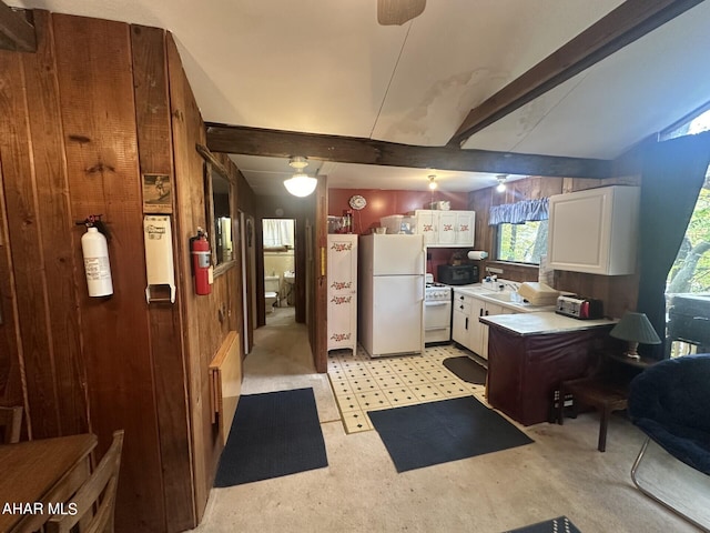 kitchen with white cabinetry, sink, vaulted ceiling with beams, wood walls, and white appliances