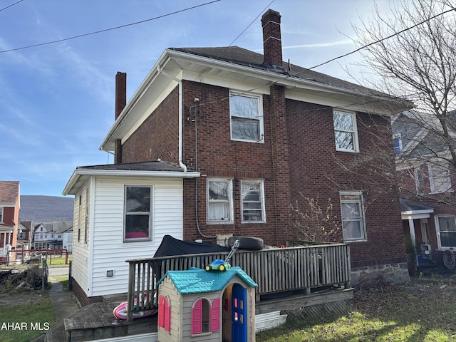 back of house featuring a deck