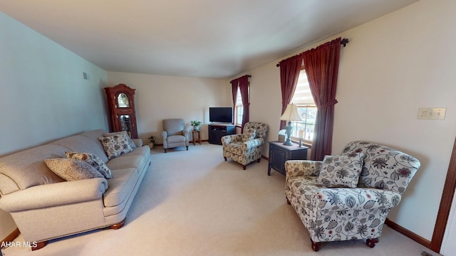 living room featuring carpet flooring, baseboards, and visible vents