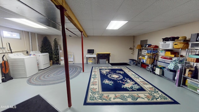 basement with independent washer and dryer and a paneled ceiling