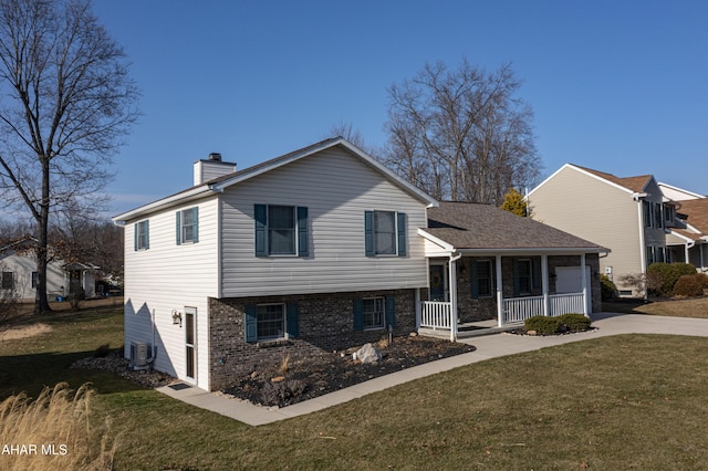 tri-level home with driveway, a front lawn, a porch, cooling unit, and a chimney