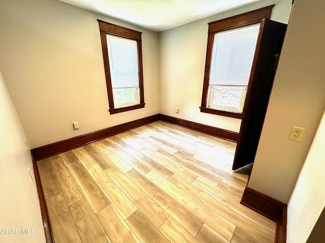 empty room featuring a healthy amount of sunlight and light wood-type flooring