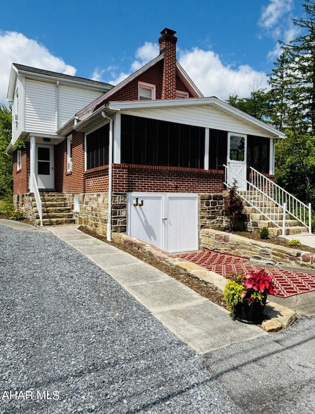 view of front of house featuring a sunroom