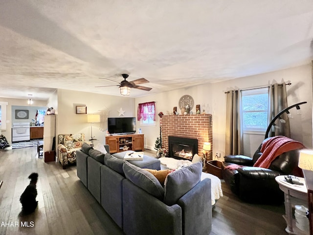 living room with a fireplace, hardwood / wood-style flooring, and ceiling fan