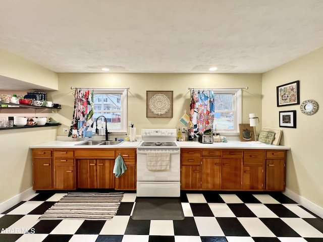 kitchen featuring white electric range oven and sink