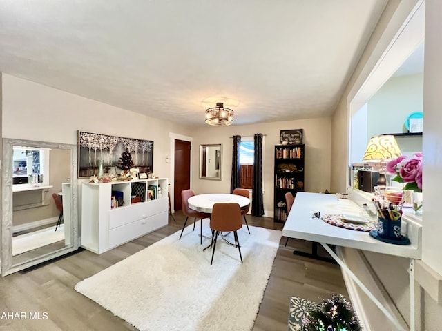 dining room featuring hardwood / wood-style flooring and a chandelier