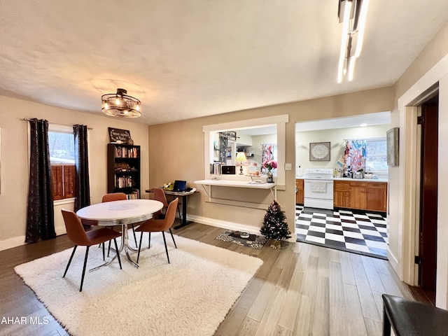 dining room with a notable chandelier and light hardwood / wood-style floors