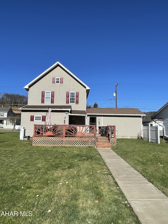 view of front of property featuring a front yard and a wooden deck