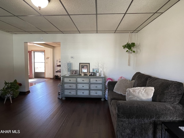 sitting room featuring dark hardwood / wood-style floors and a drop ceiling