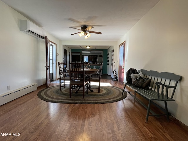 dining room with hardwood / wood-style flooring, baseboard heating, a wall mounted AC, and ceiling fan